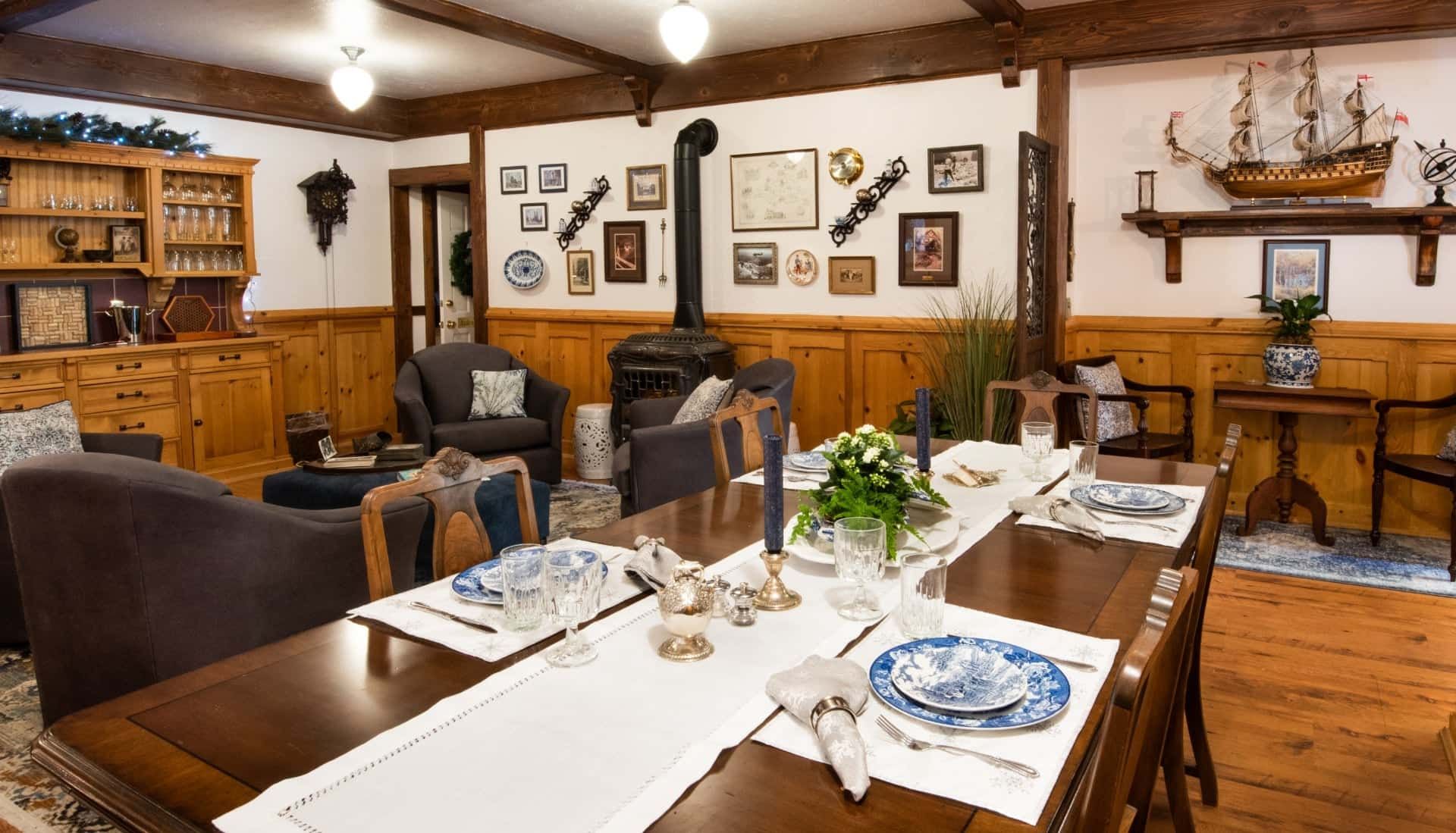 A living room with a long dining table and chairs.