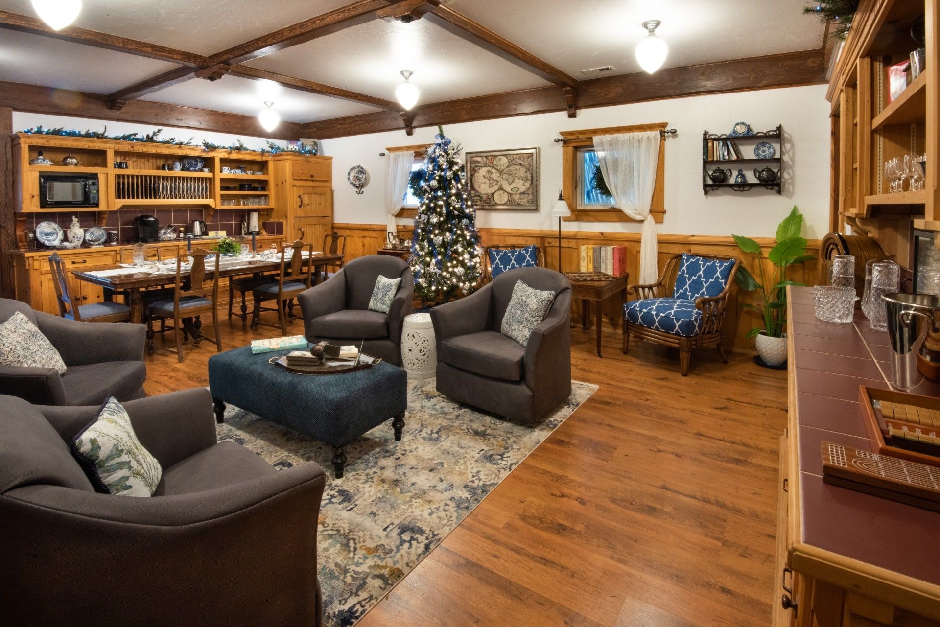 A living room filled with furniture and a christmas tree.
