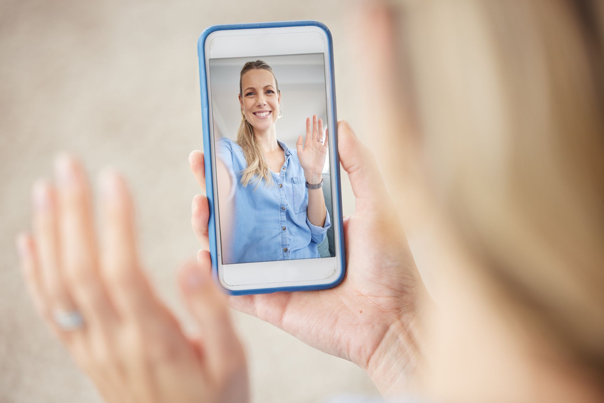 A woman is taking a picture of herself on her cell phone.