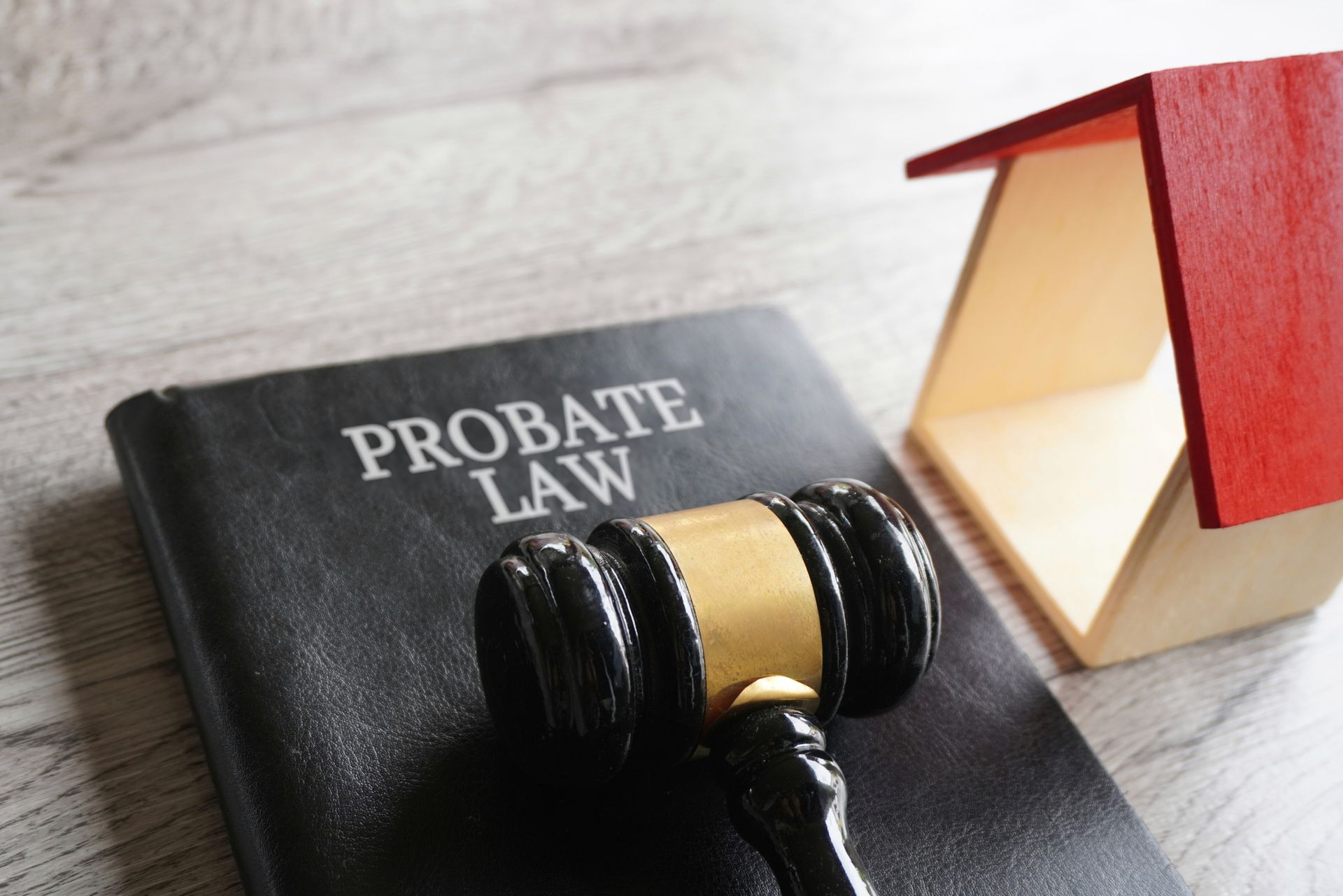 A gavel is sitting on top of a book titled probate law.