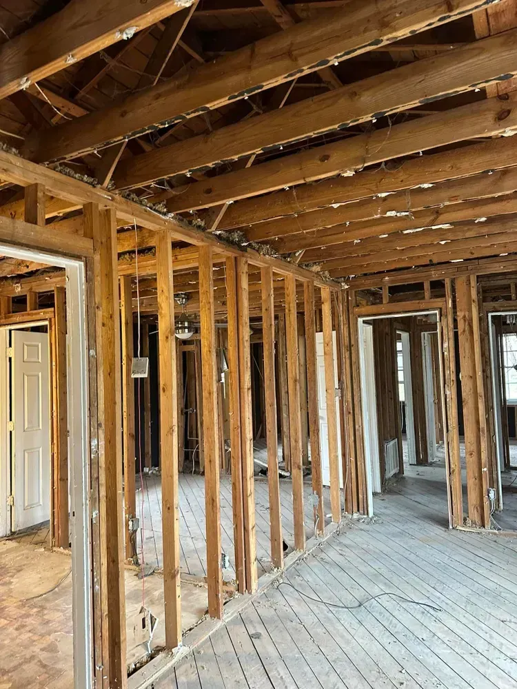 The inside of a house under construction with wooden beams.