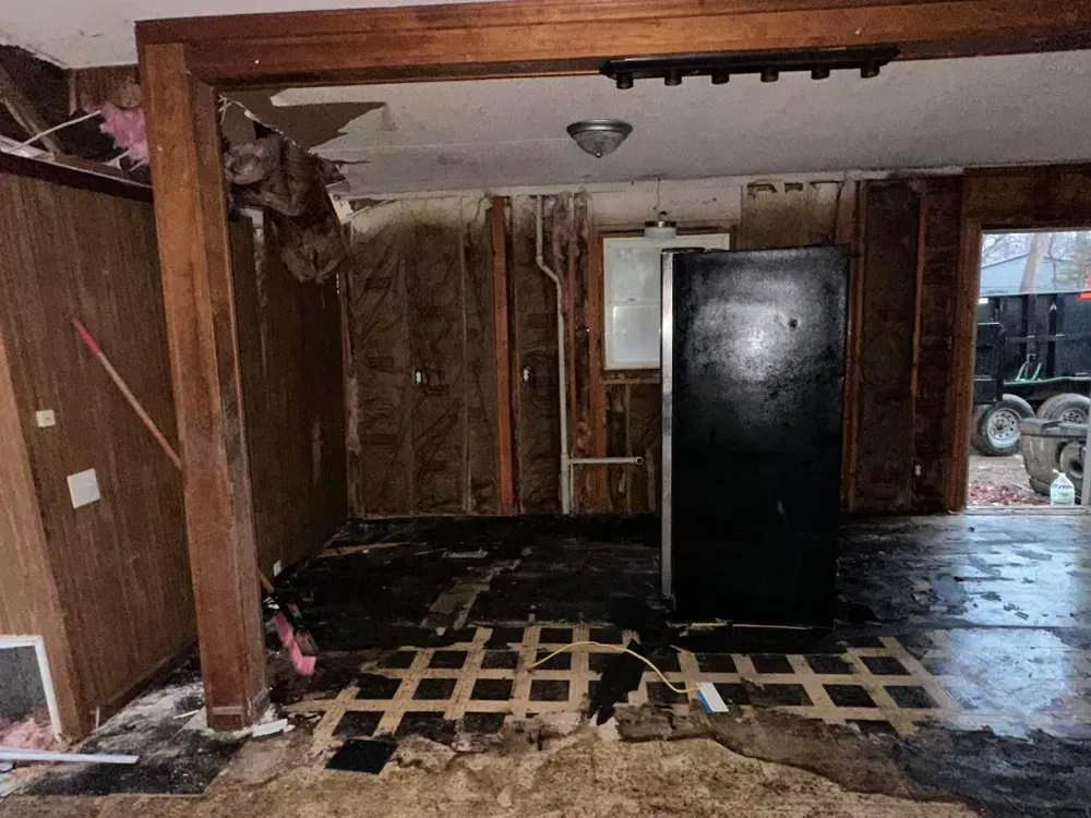 There is a refrigerator in the middle of the room.