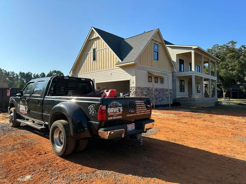 A truck is parked in front of a house under construction.