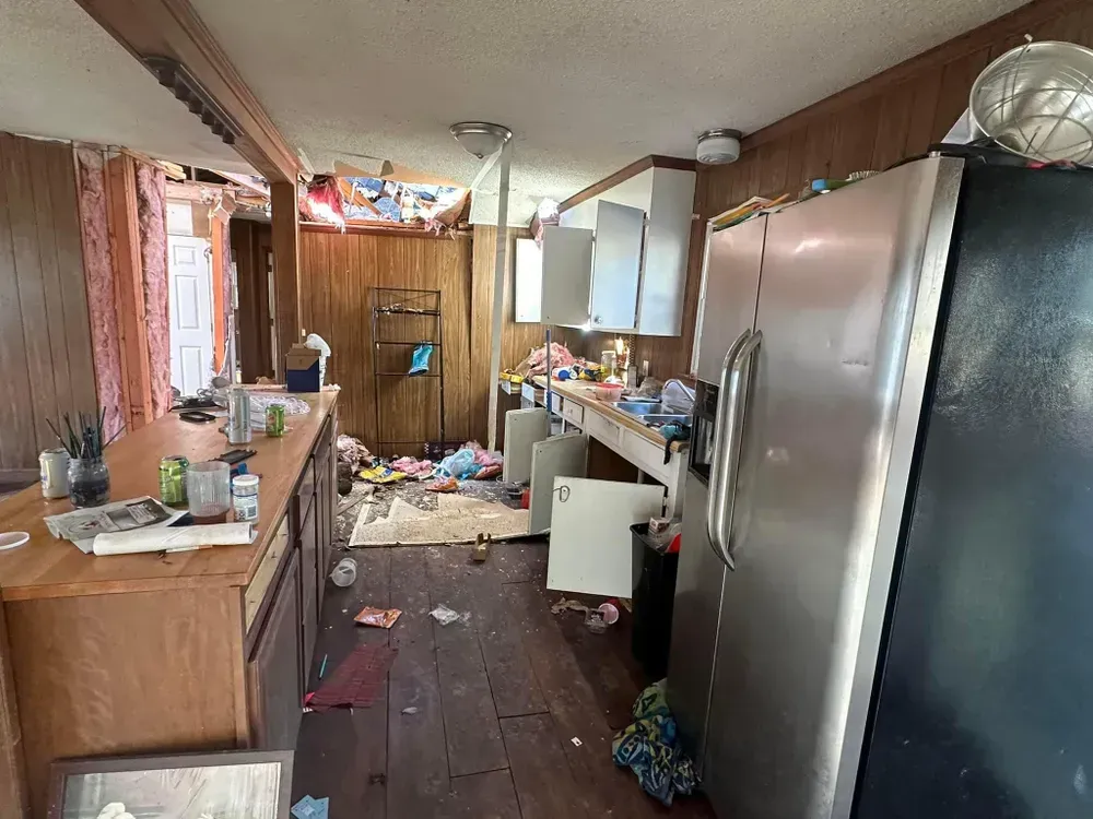 A kitchen with a refrigerator , sink , and cabinets.