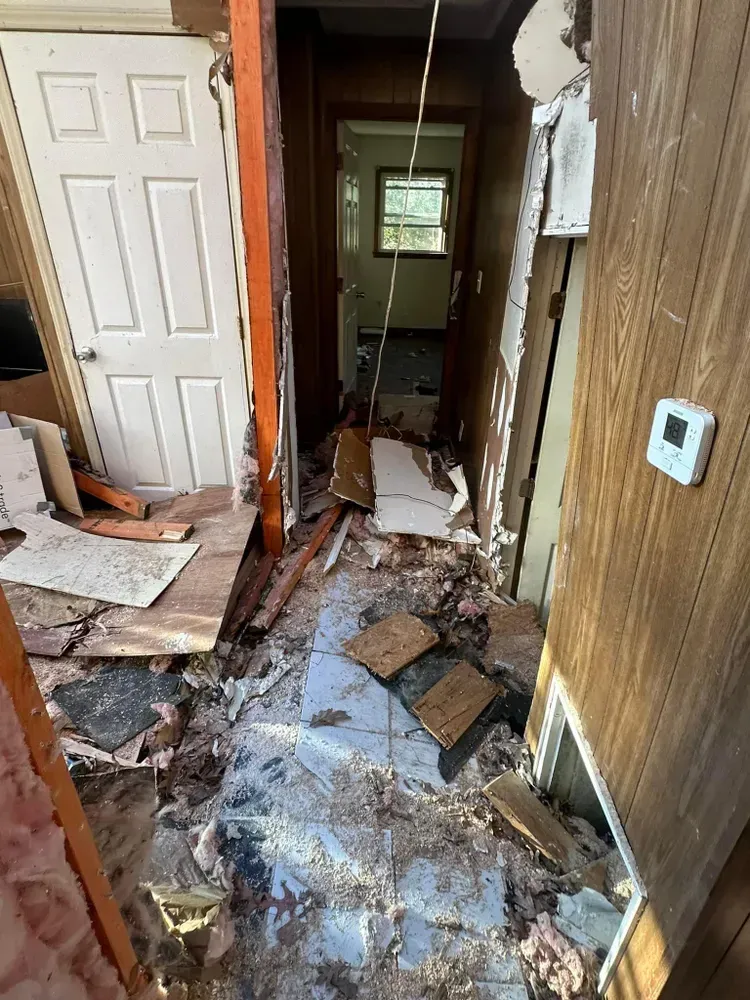 A hallway in a house that is being demolished.