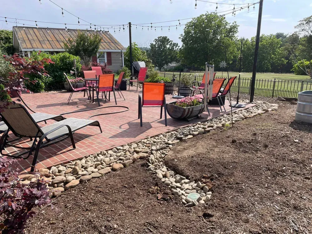 There are many chairs and tables on the patio.