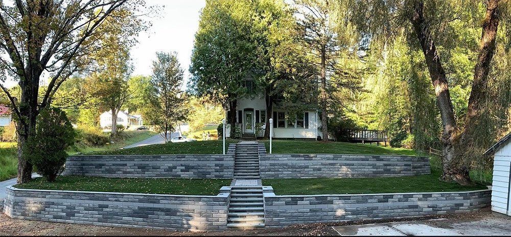 House with Multi Level Retaining Wall — Pine Bush, NY — Creative Touch Landscaping & Home Improvement Inc.