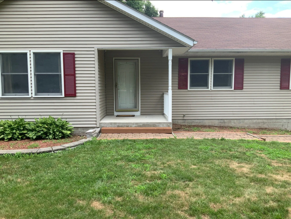 Machine Beside Retaining Wall — Rock Tavern, NY — Creative Touch Landscaping & Creative Touch Landscaping & Supply
