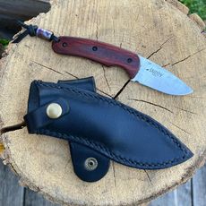 A freshly sharpened knife with a leather protector