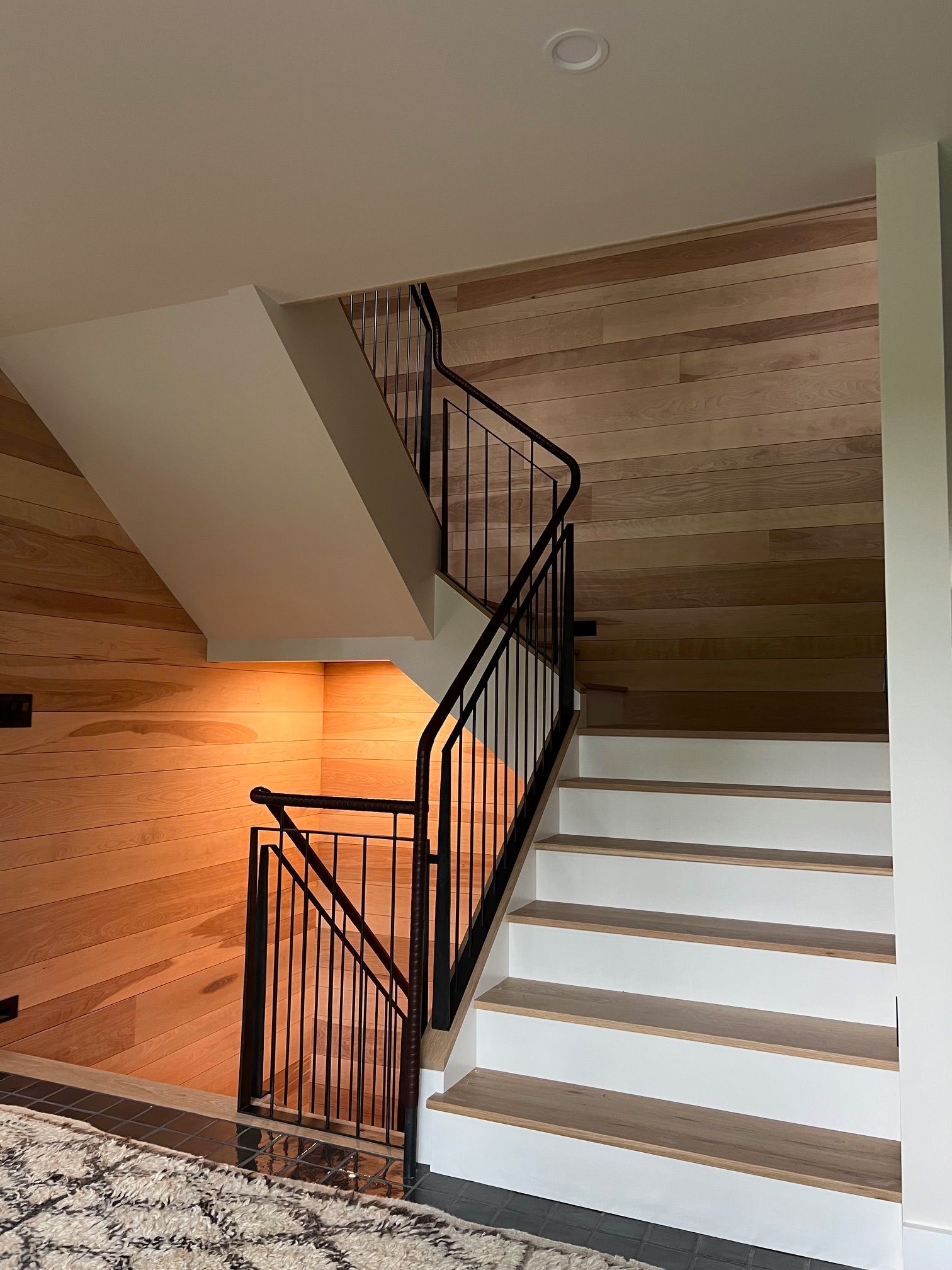 A staircase with wooden steps featuring leather trim