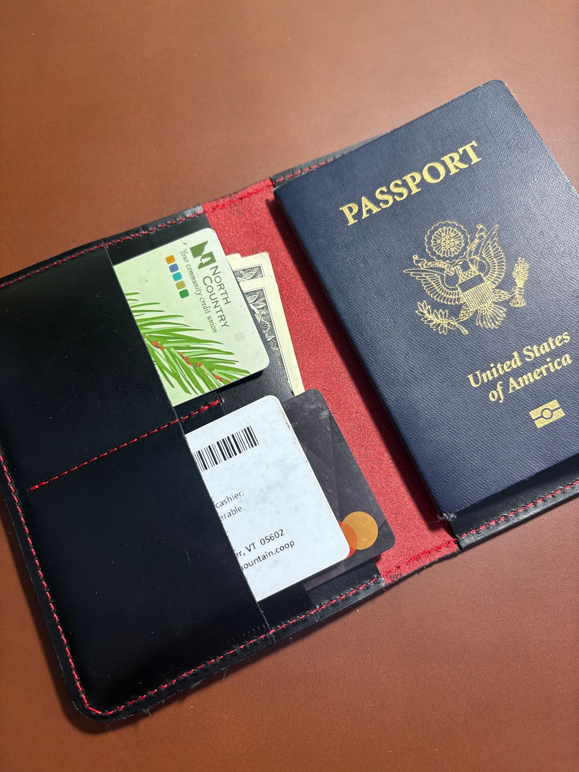 Passport and wallet with cards and cash.