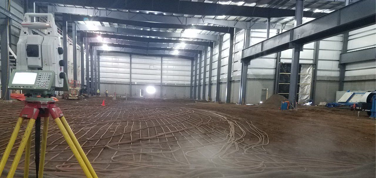 A tripod is sitting in the middle of a large building.