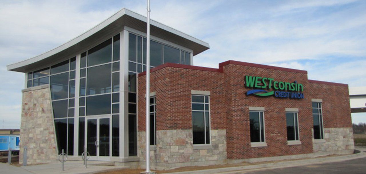 A large brick building with a green sign that says westconsin