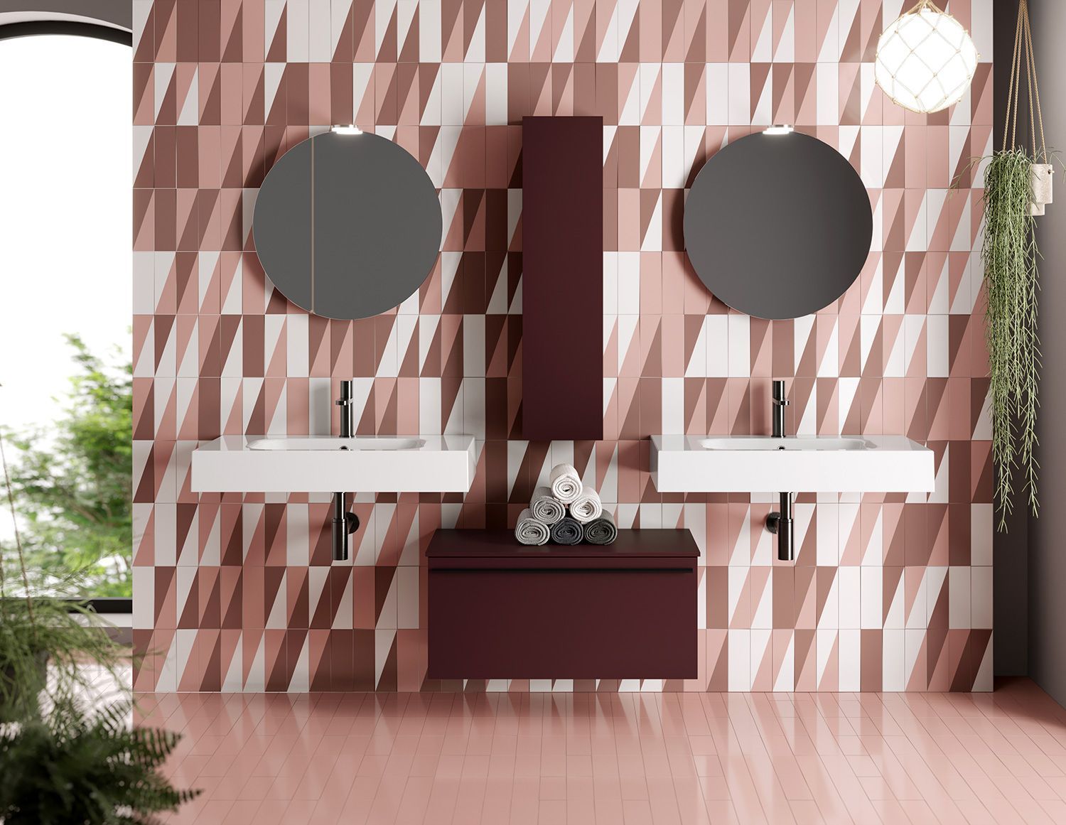 Moderno mobile bagno doppio con lavabi bianchi, specchi circolari e pareti rivestite con piastrelle geometriche rosa e bianche.