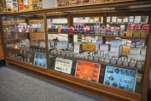 Display case filled with various locks and related hardware in a store.