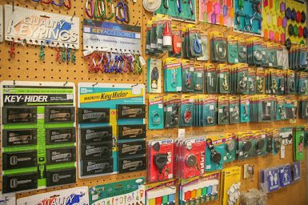 Pegboard displaying various key-related items: keyrings, key hiders, and key blanks.