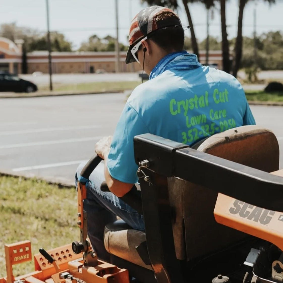 Owner of crystal cut lawn care mowing a lawn in Spring Hill, FL.