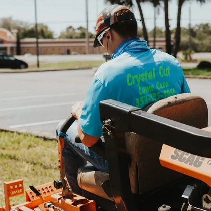 Owner of crystal cut lawn care mowing a lawn in Spring Hill, FL.