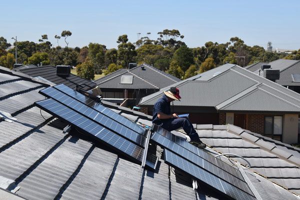 Man on the Roof with Solar Panels — Electrical Services in Lake Gardens VIC