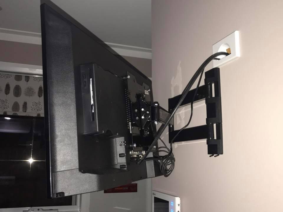 Flat Screen Tv Mounted on A Wall With a Cord — Electrician in Lake Gardens VIC