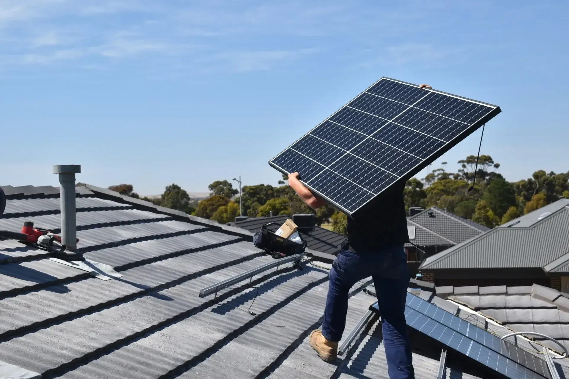 Man on the Roof Caring Solar Panel— Solar Panels in Lake Gardens VIC