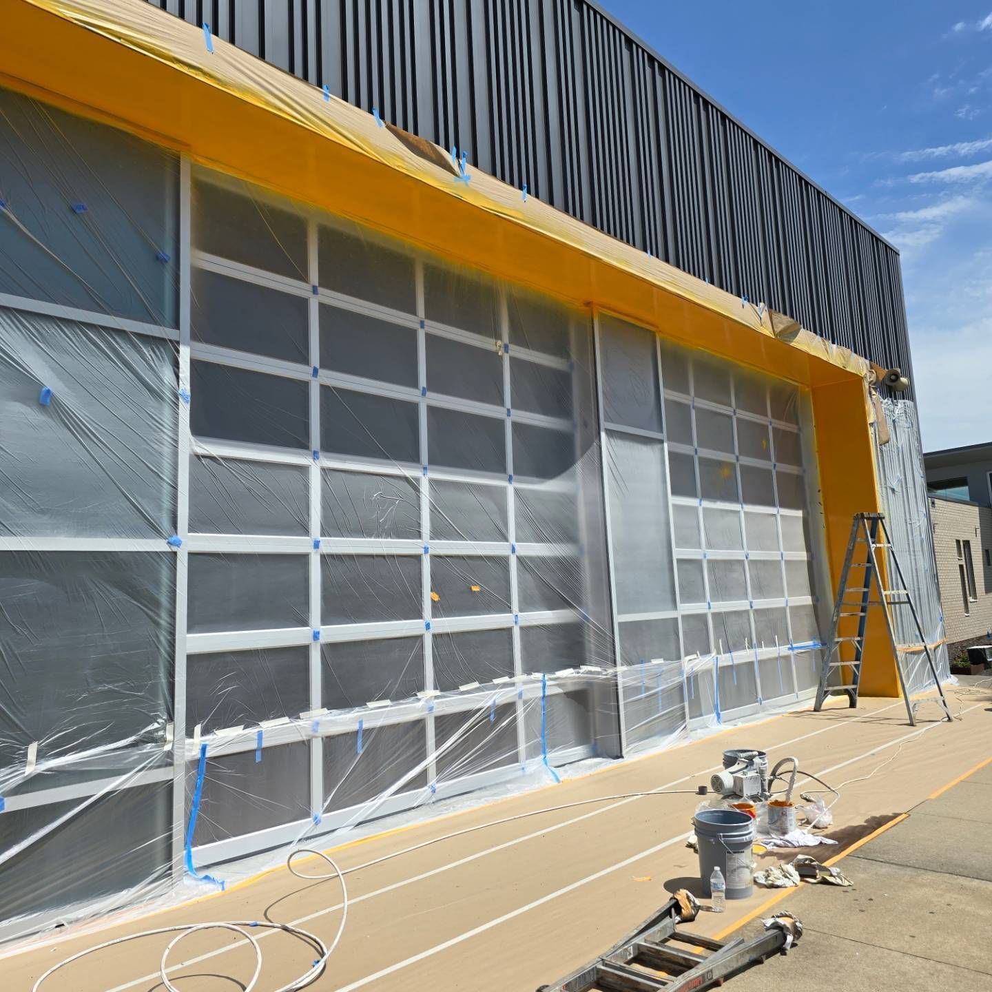 A building with a lot of windows is being painted