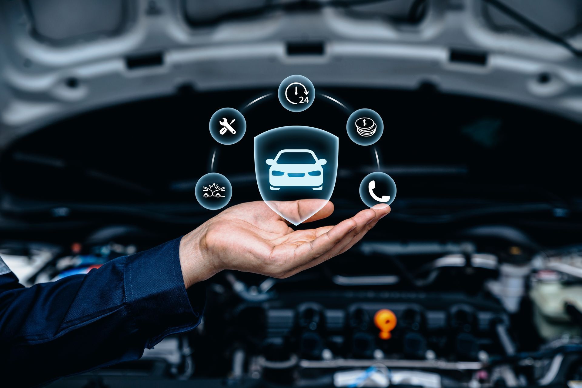 A person is holding a car in their hand in front of a car engine.