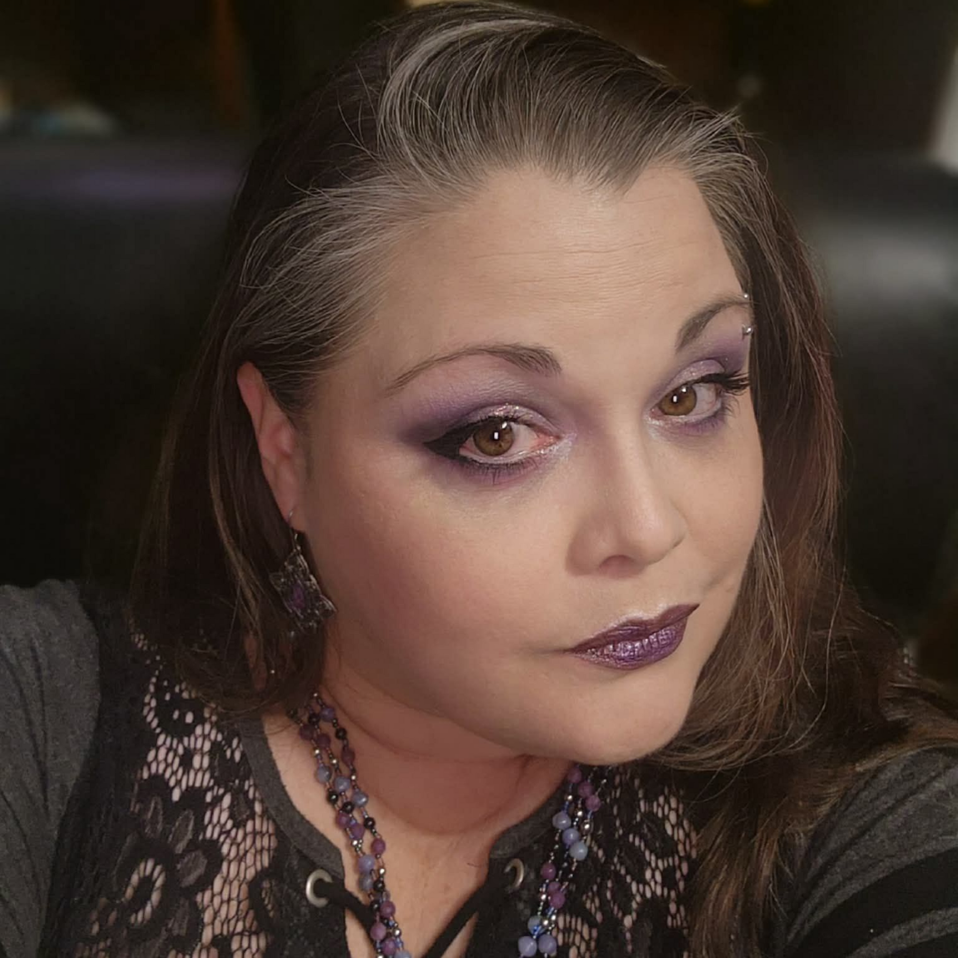 The logo for the spiritual professionals association has a hamsa hand with a purple eye.