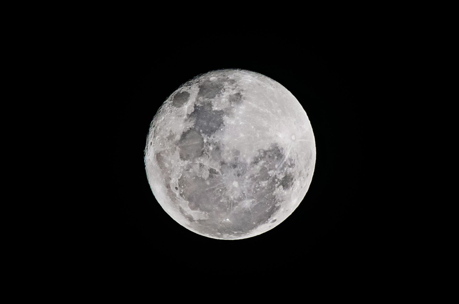 A full moon is visible in the night sky.