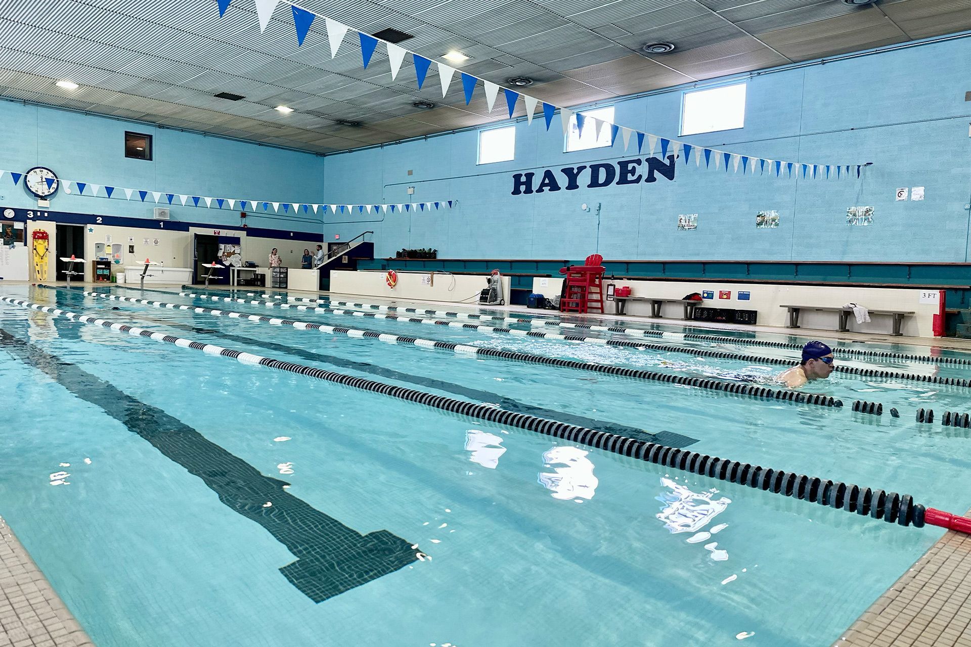A large indoor swimming pool with the name hayden on the wall