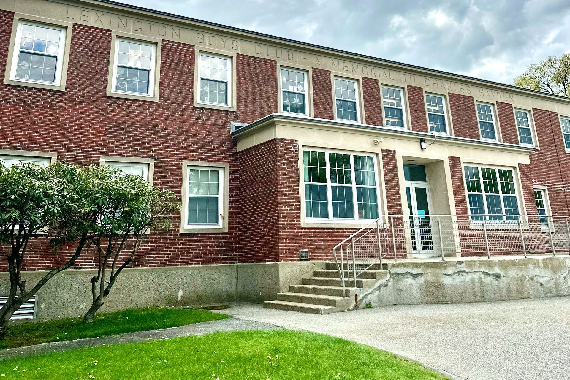 A large brick building with a lot of windows and stairs