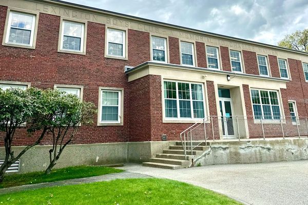 A large brick building with a lot of windows and stairs