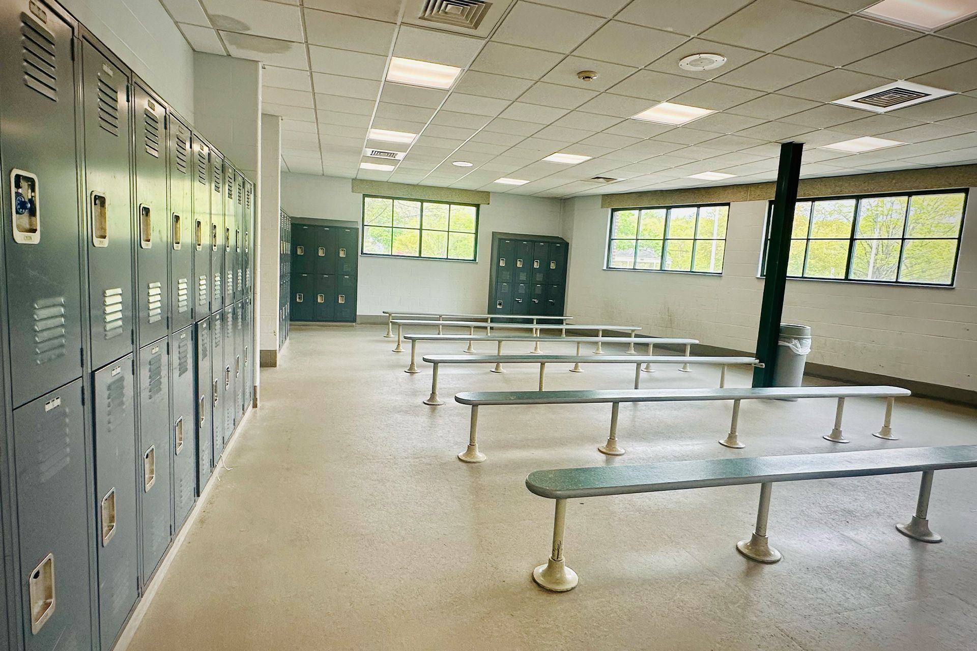 A locker room with lots of lockers and benches