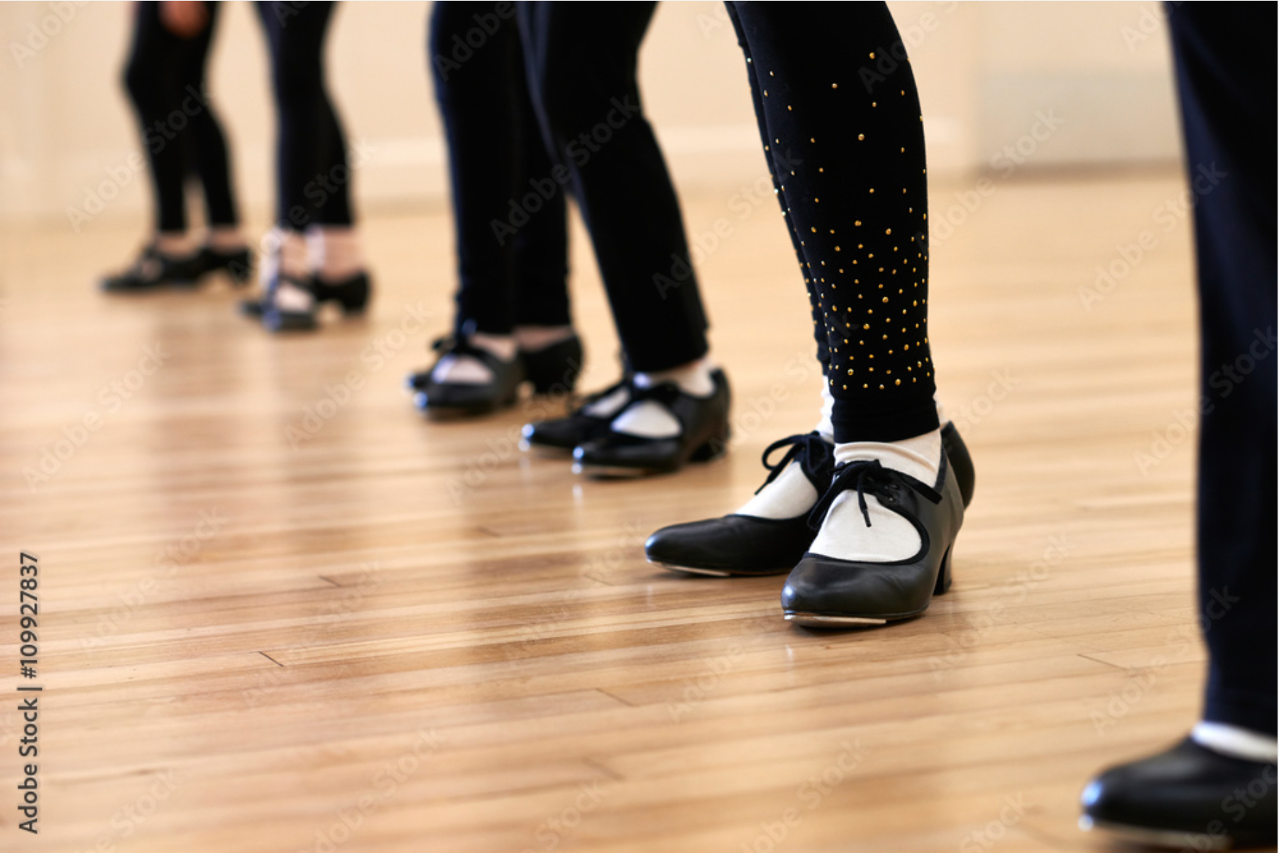 A group of people are dancing tap in a dance studio.