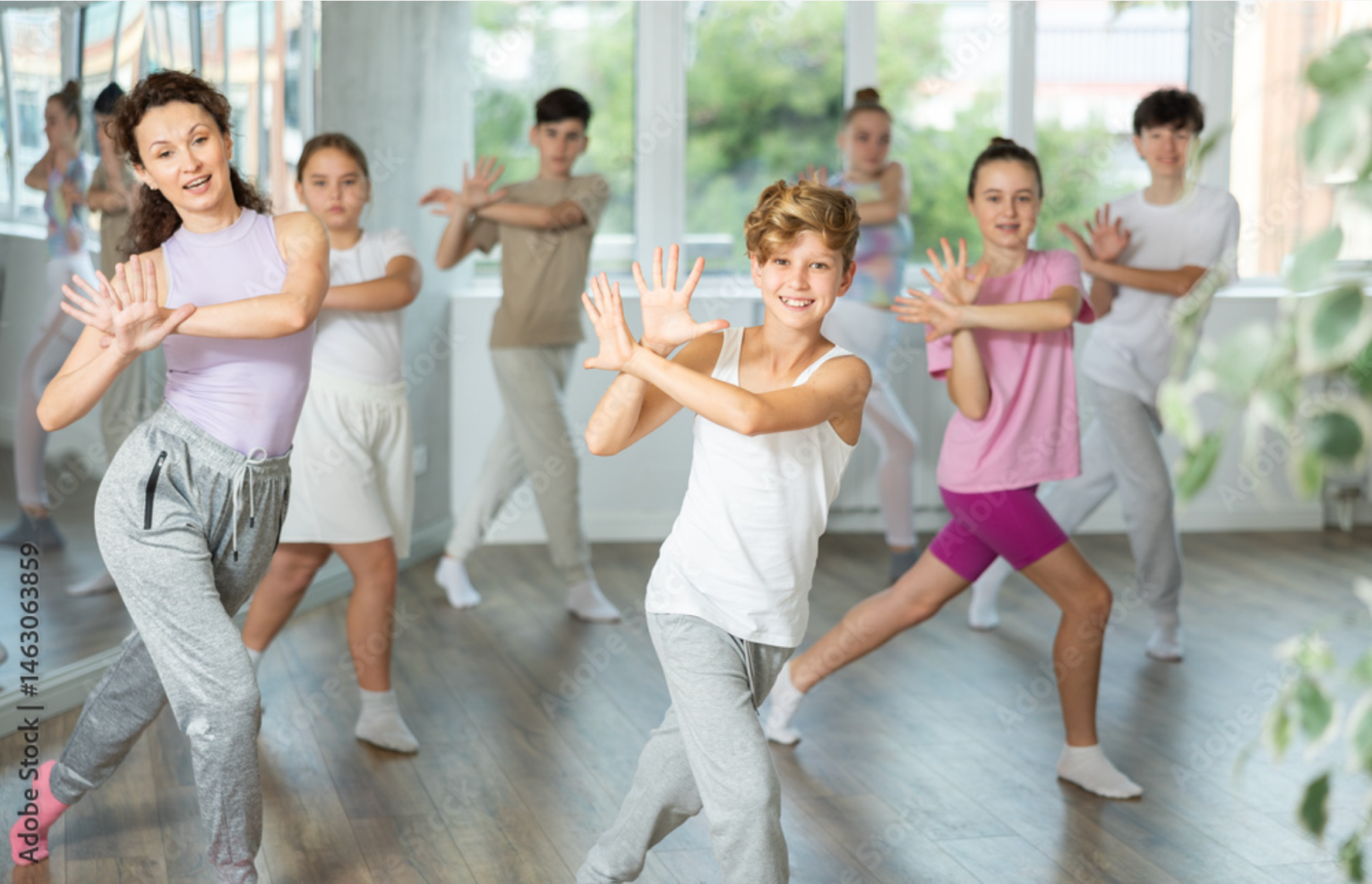 A group of children are dancing in a dance studio.