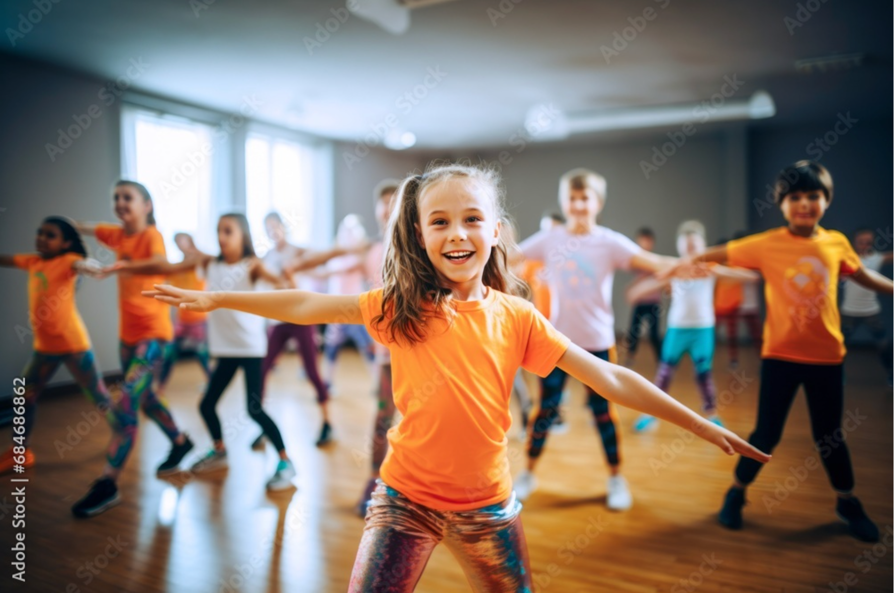 A group of children are dancing together in a dance studio.