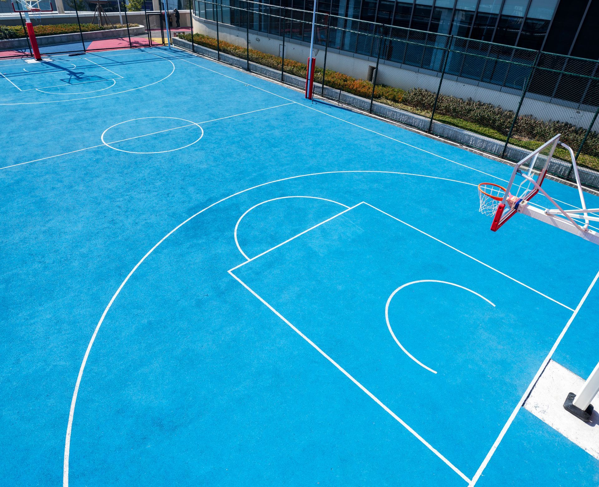 Blue Basketball Court with White Lines and A Red Backboard Hoop — Tucker, GA — A-1 Driveway Replacement Company