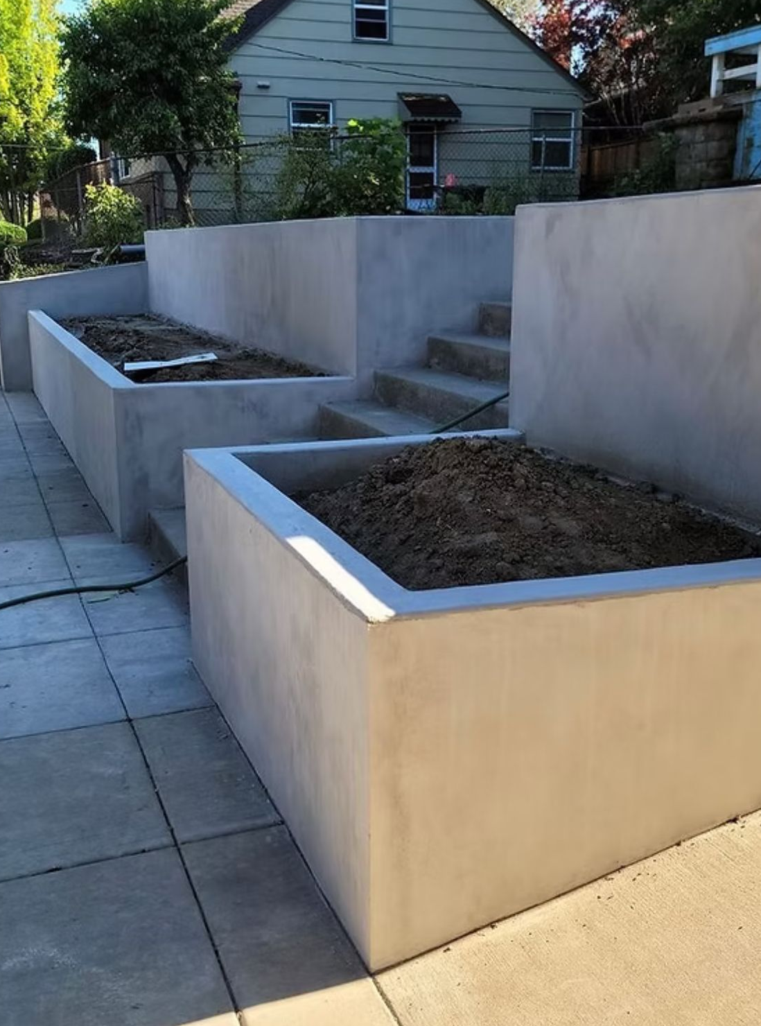 Stone Retaining Wall Bordering a Gravel Path and Greenery — Tucker, GA — A-1 Driveway Replacement Company