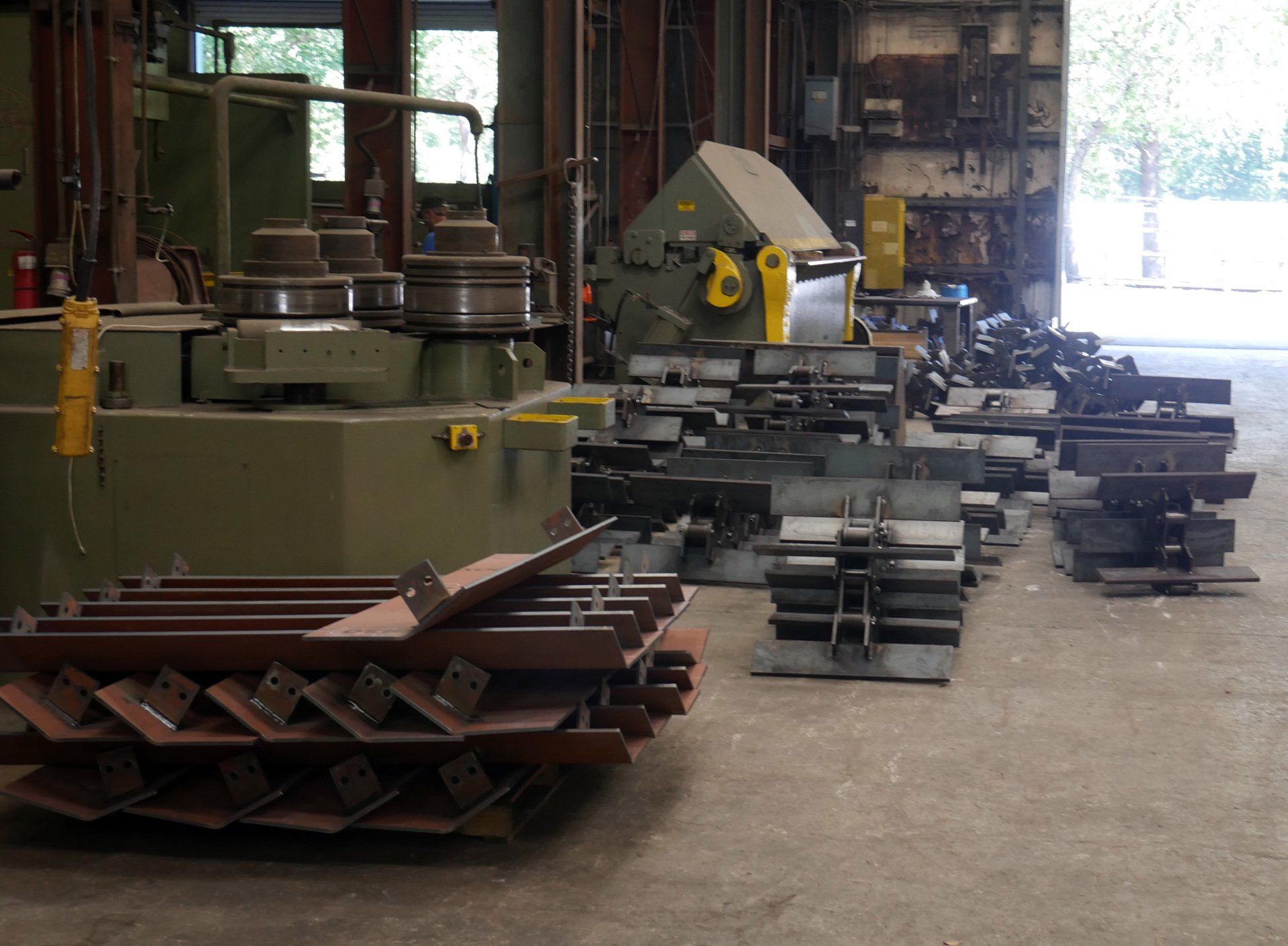 A warehouse filled with lots of machinery and pieces of metal