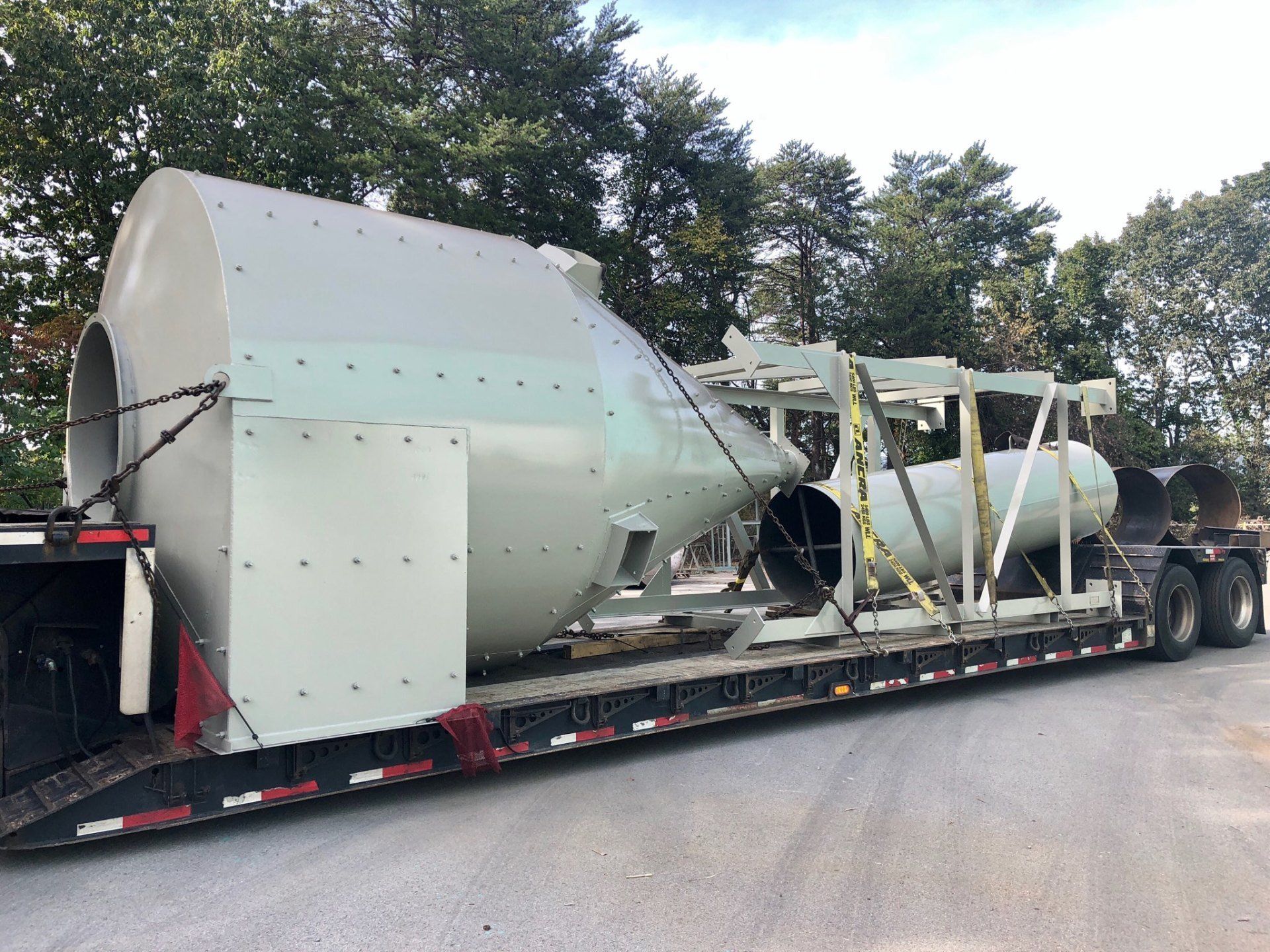 A large white object is sitting on top of a trailer.
