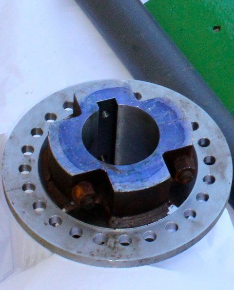 A close up of a metal disc with holes in it