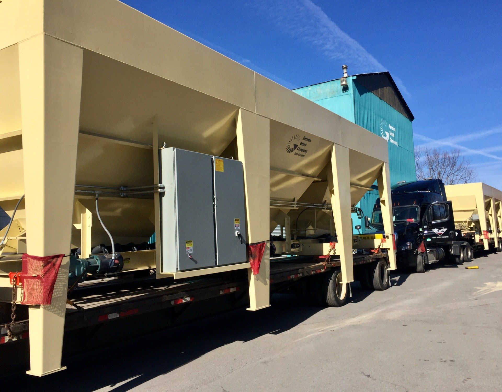 A row of trucks are parked in front of a building