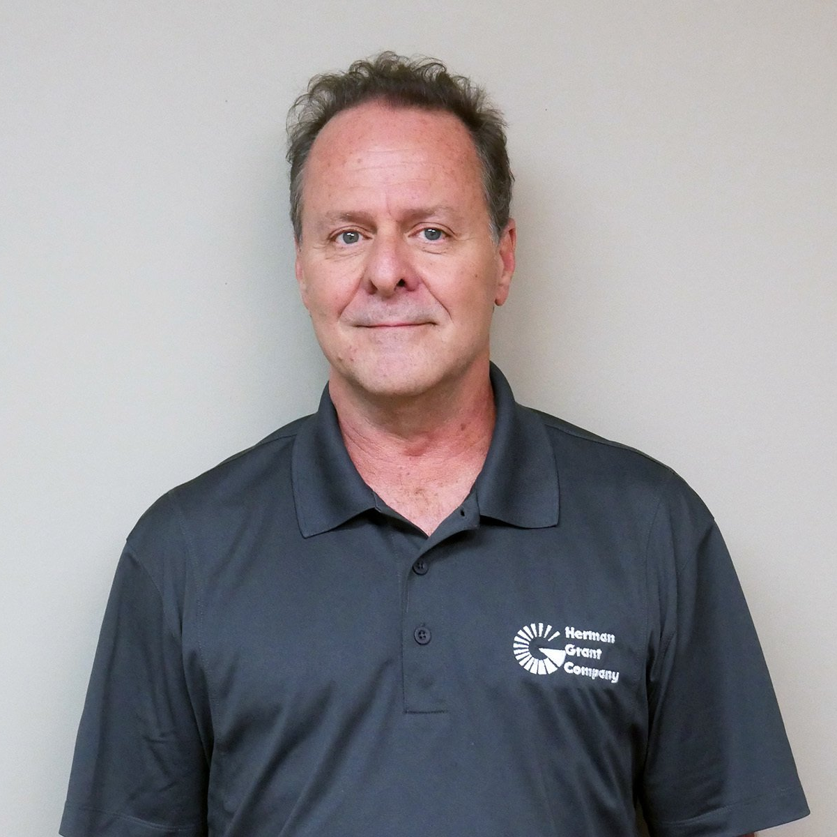 A man wearing a polo shirt with the word security on it