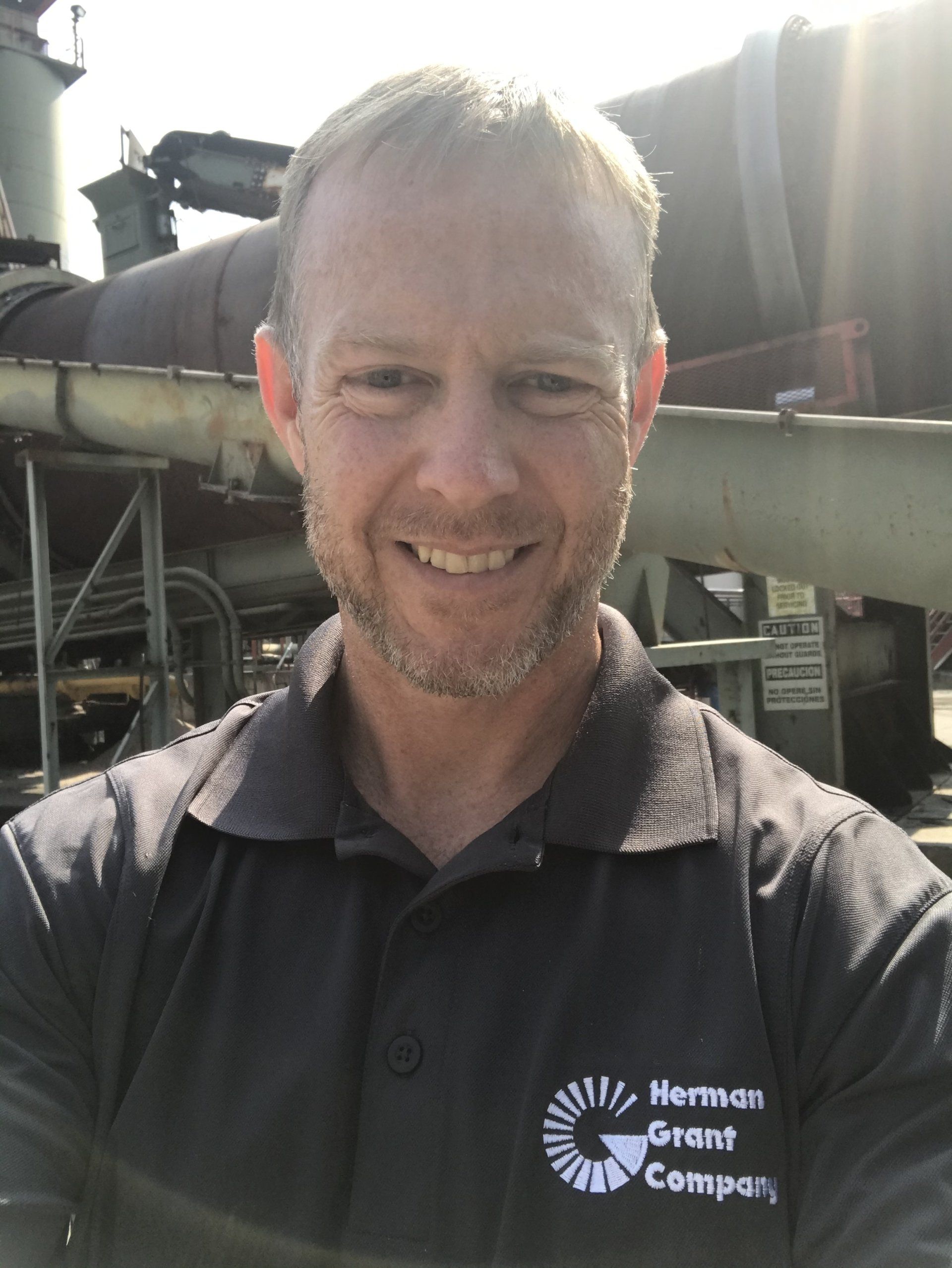 A man wearing a black shirt with the word company on it