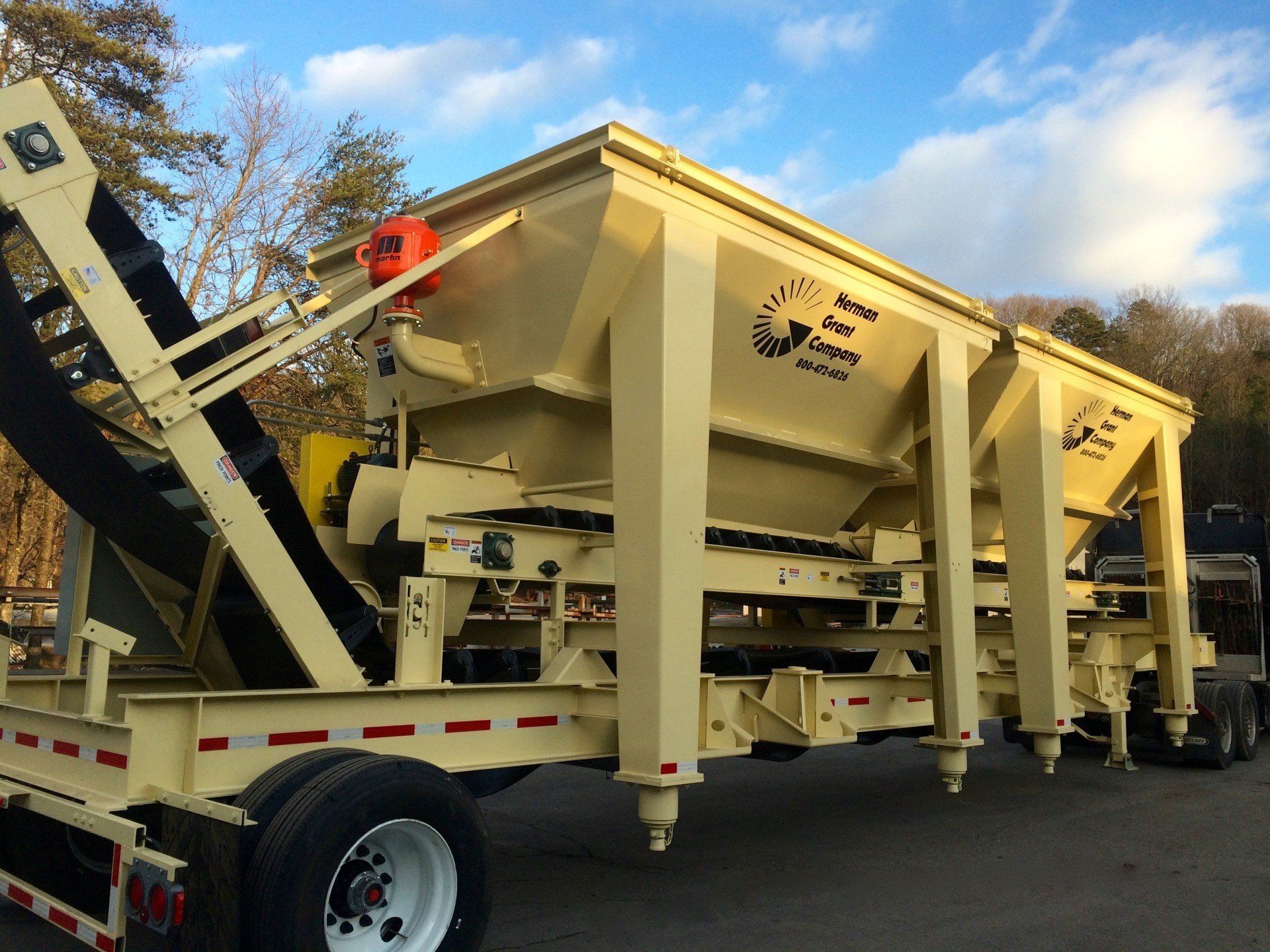 A large container with a conveyor belt attached to it