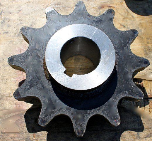 A close up of a metal gear with a hole in the middle