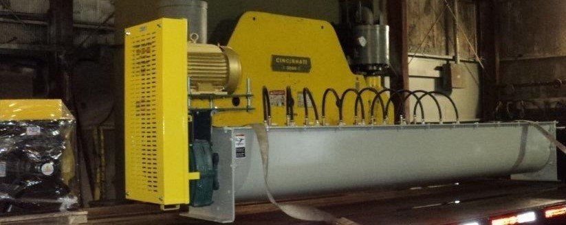 A large yellow machine is sitting in a dark room.