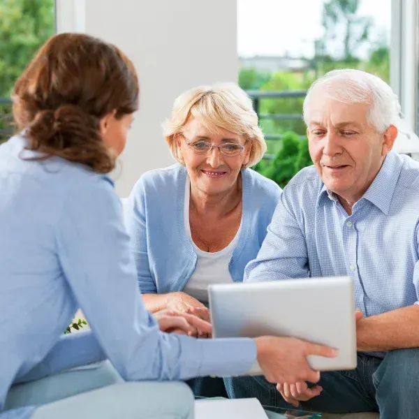 An image showing a family discussing final expense insurance with an agent.