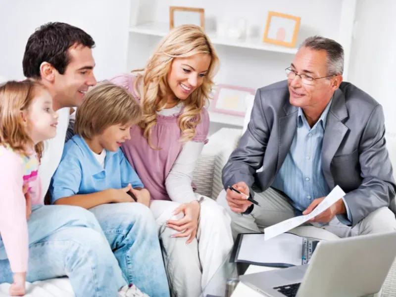 An image showing a family discussing whole life insurance options with an agent.