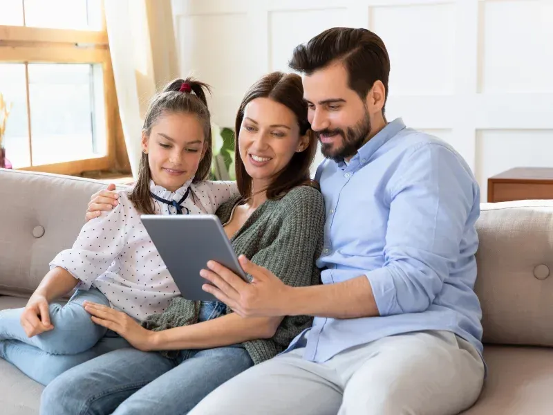 An image showing a happy family looking at whole life insurance protection options.